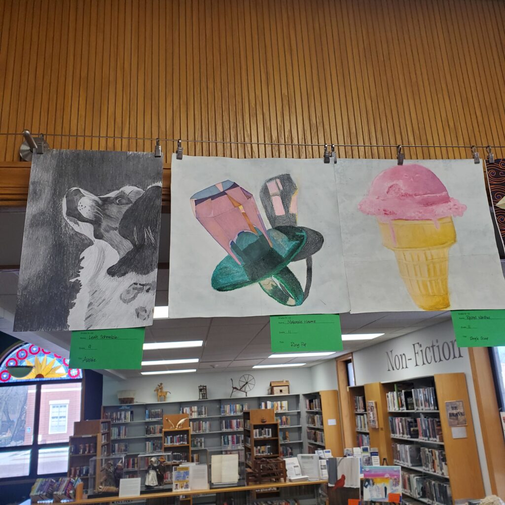 Left is a graphite illustration of a dog. Center is a ring pop with a shadow version behind it. Right is a highly detailed marker and colored pencil drawing of strawberry ice cream in a waffle cup.