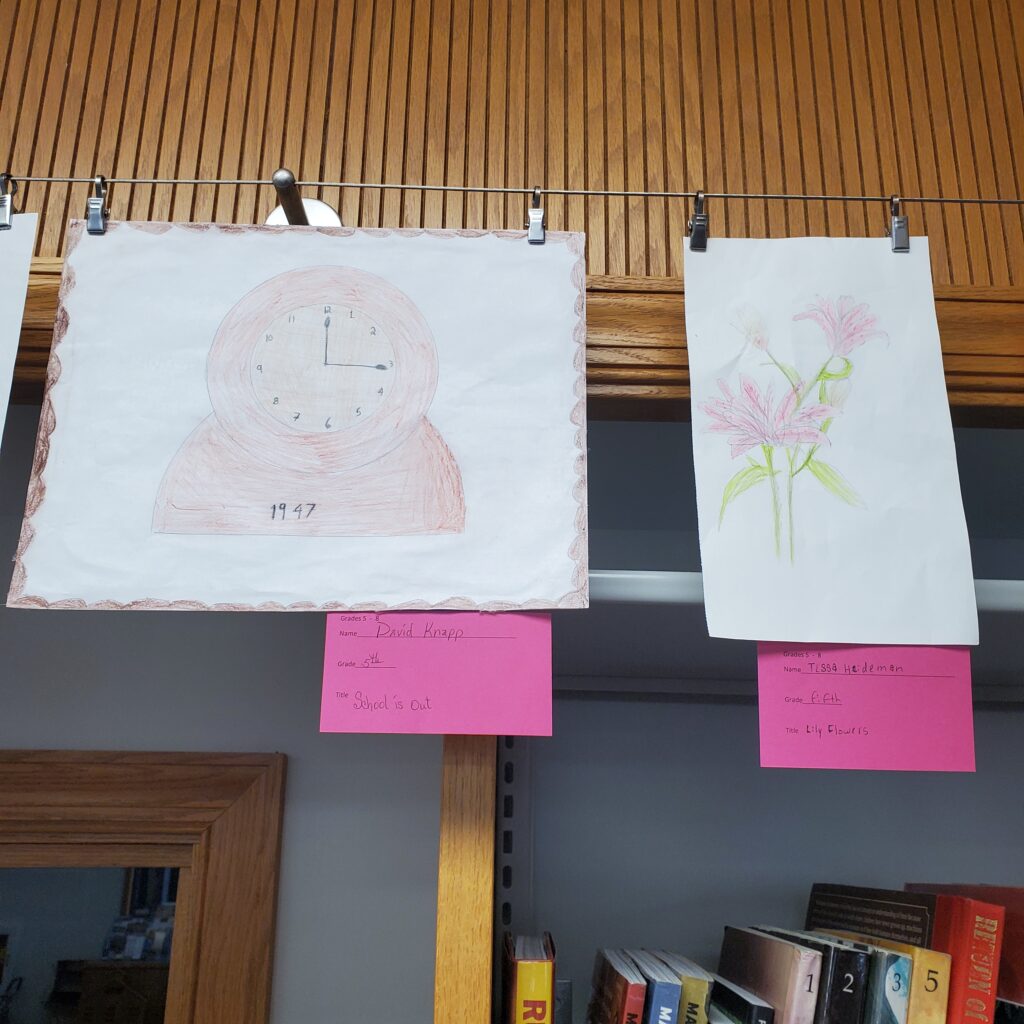 Left a pencil and colored pencil sketch of a mantle piece clock. Right a pencil and colored pencil drawing of flowers.