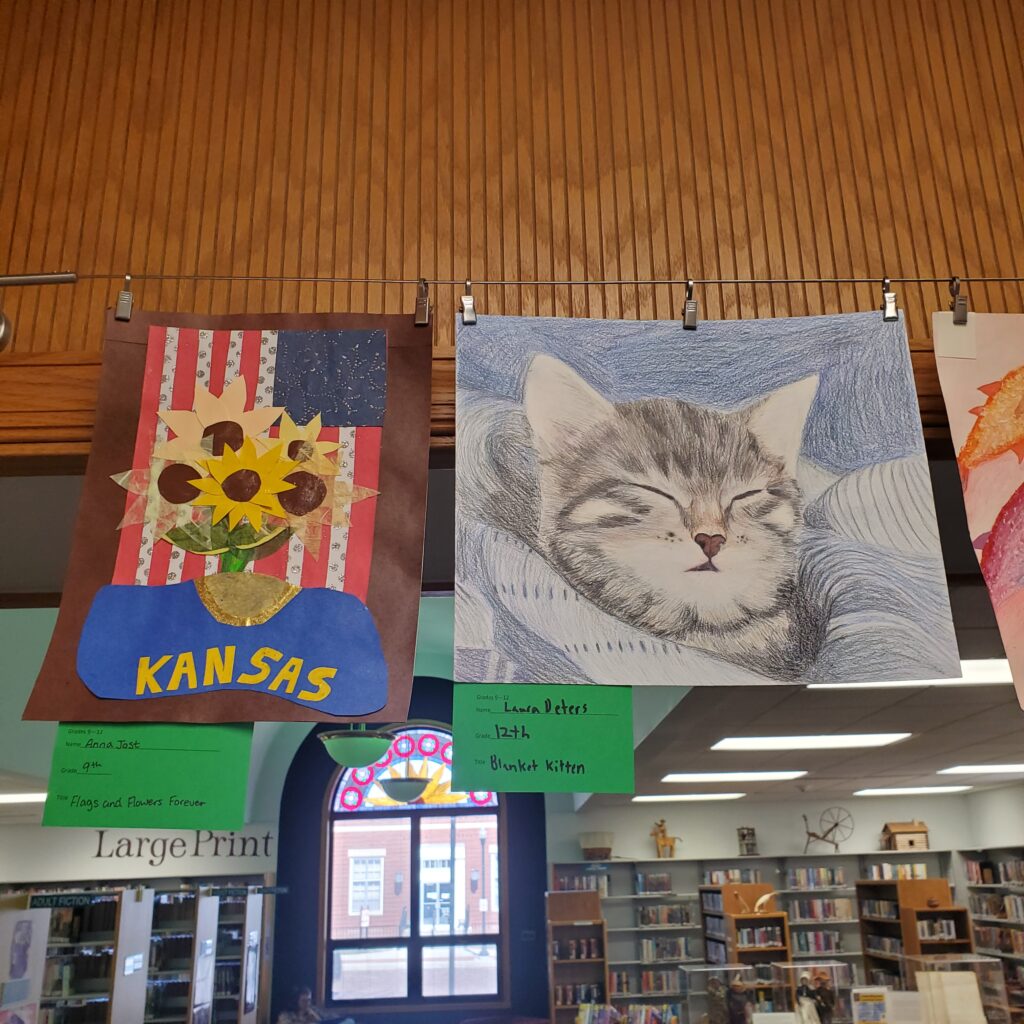 Mixed Media Sunflowers with US and Kansas Flags. Color Pencil sketch of kitten in a blanket.