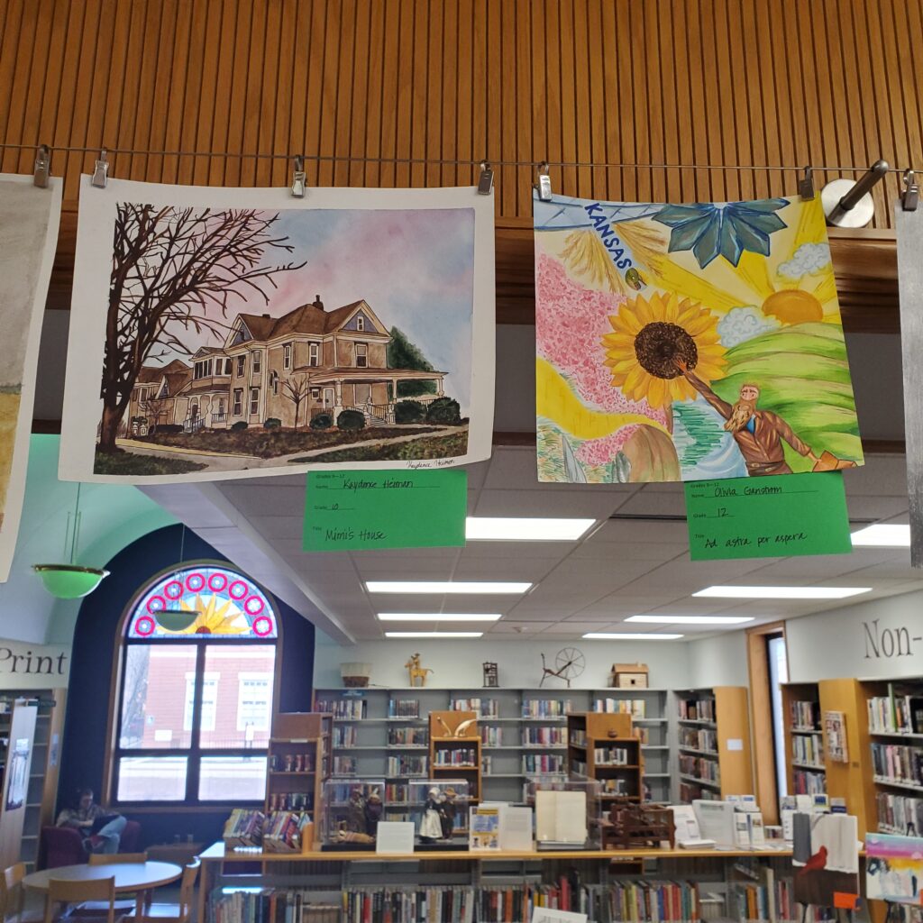 Left is a highly detailed illustration of a house. Right is a multi-media sunflower and other Kansas iconography.