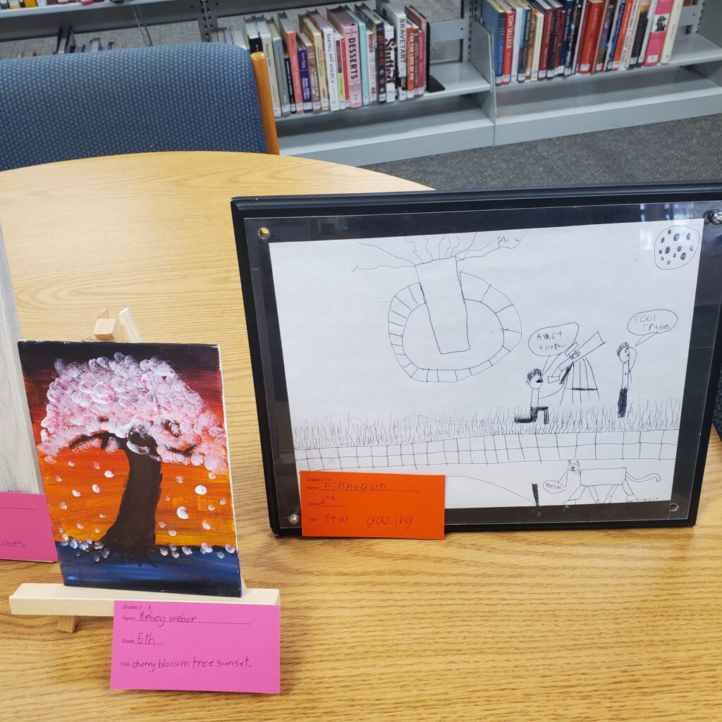 At left a painting of a cherry blossom tree at sunset. At right a pencil sketch of two people using a telescope.