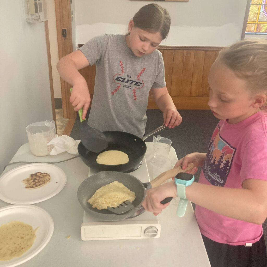 Participants pan fry their crepes.