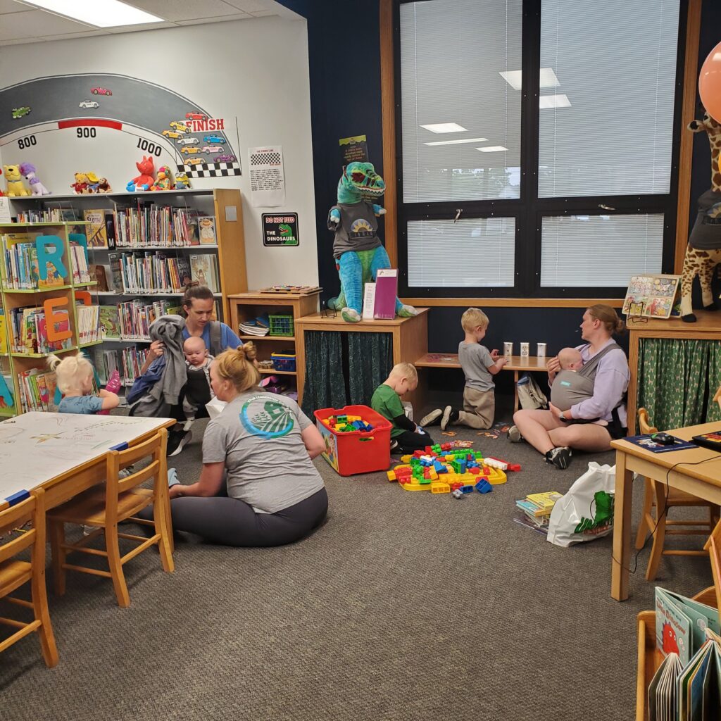 Parents and kids play in the children's section.