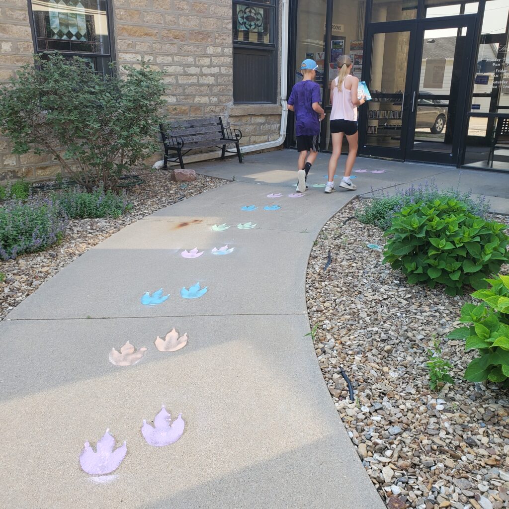 Chalk dino prints lead to the front door.
