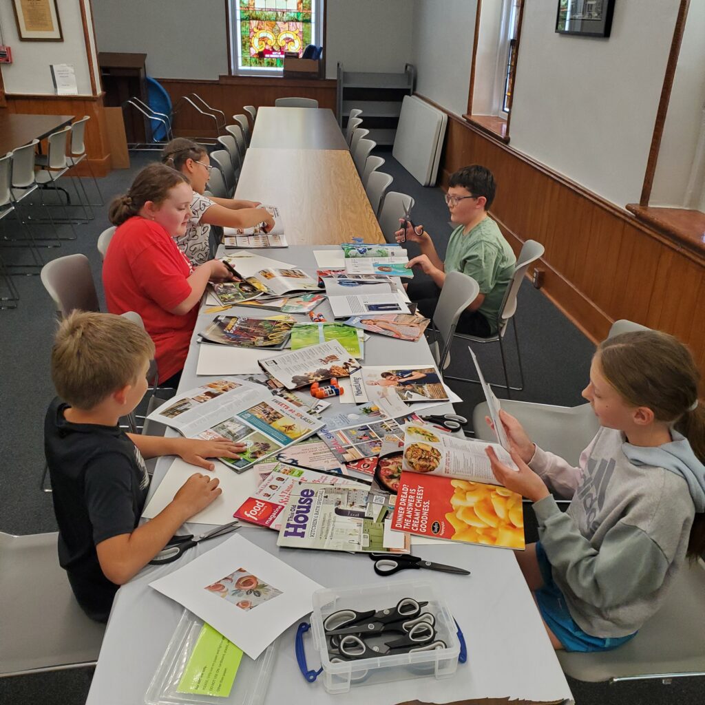 Cutting collage materials.