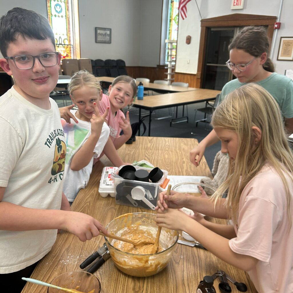 Kids mixing ingredients and goofing for the camera.