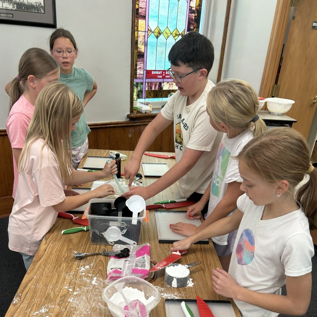 Kids Measuring dry ingredients.